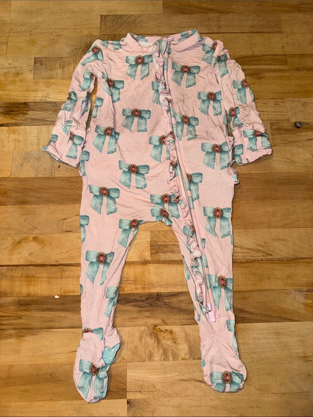 Posh Peanut Pink Footed One-Piece with Teal Bow Print